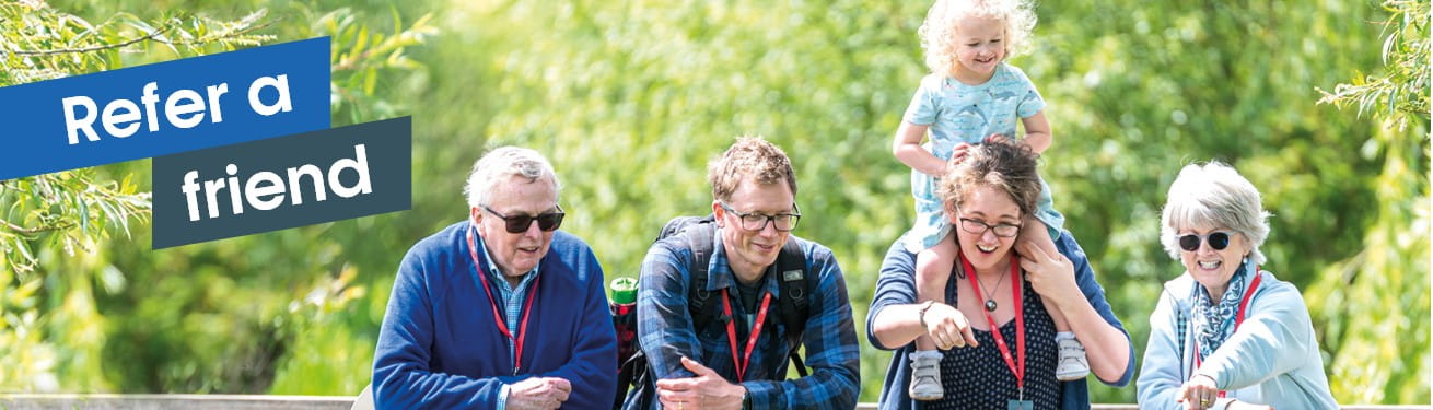 Refer a friend banner. Family enjoying a Boundless Members-day at the Wildfowl and Wetlands Trust. Mother and grandmother pointing to pond.